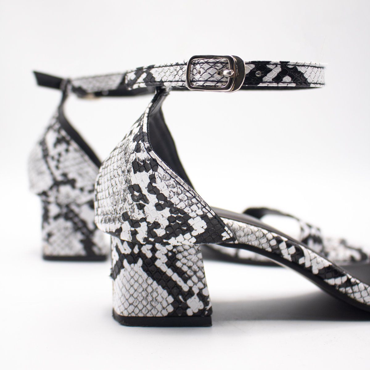 Black & White Snake Low Block Heels by Madish